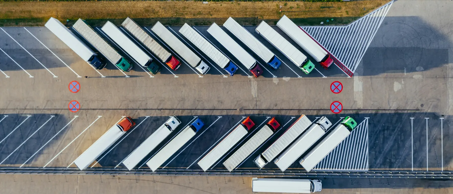 Rows of parked lorries and trailers seen from above